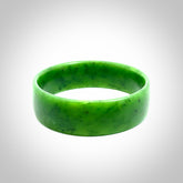 Hand carved jade bangle. Carved from green New Zealand jade. This is a solid jade bangle carved from a single piece of jade. It is polished to a sleek matte. the jade is otherwise untreated and completely natural.